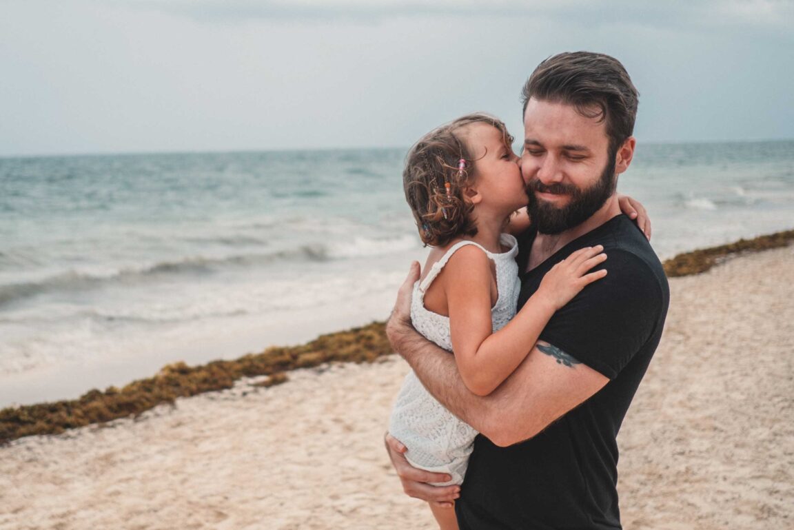 Man with daughter on beach